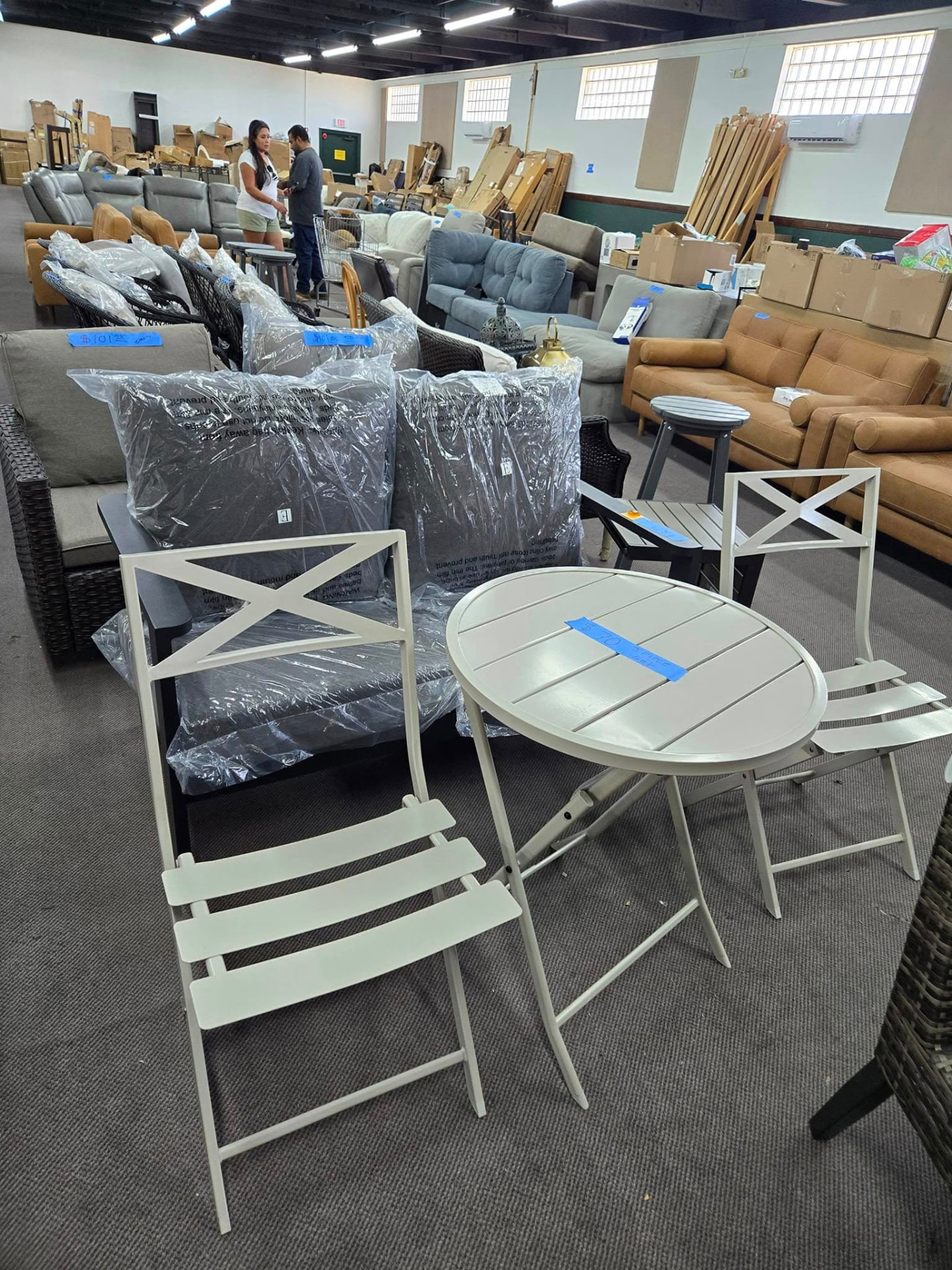 White metal bistro set in the warehouse showroom