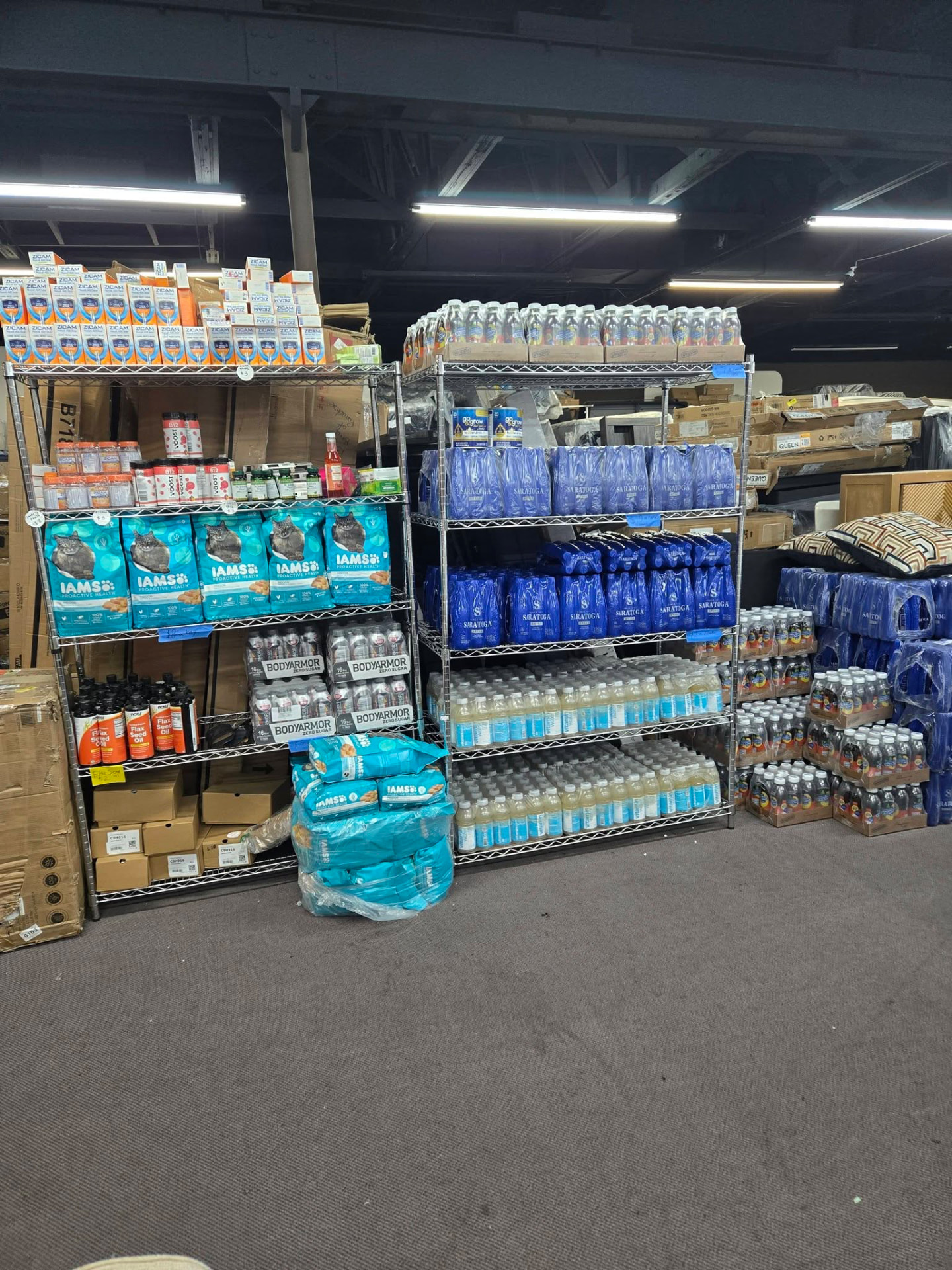 Shelving stocked with IAMS pet food, BodyArmor drinks and Saratoga water