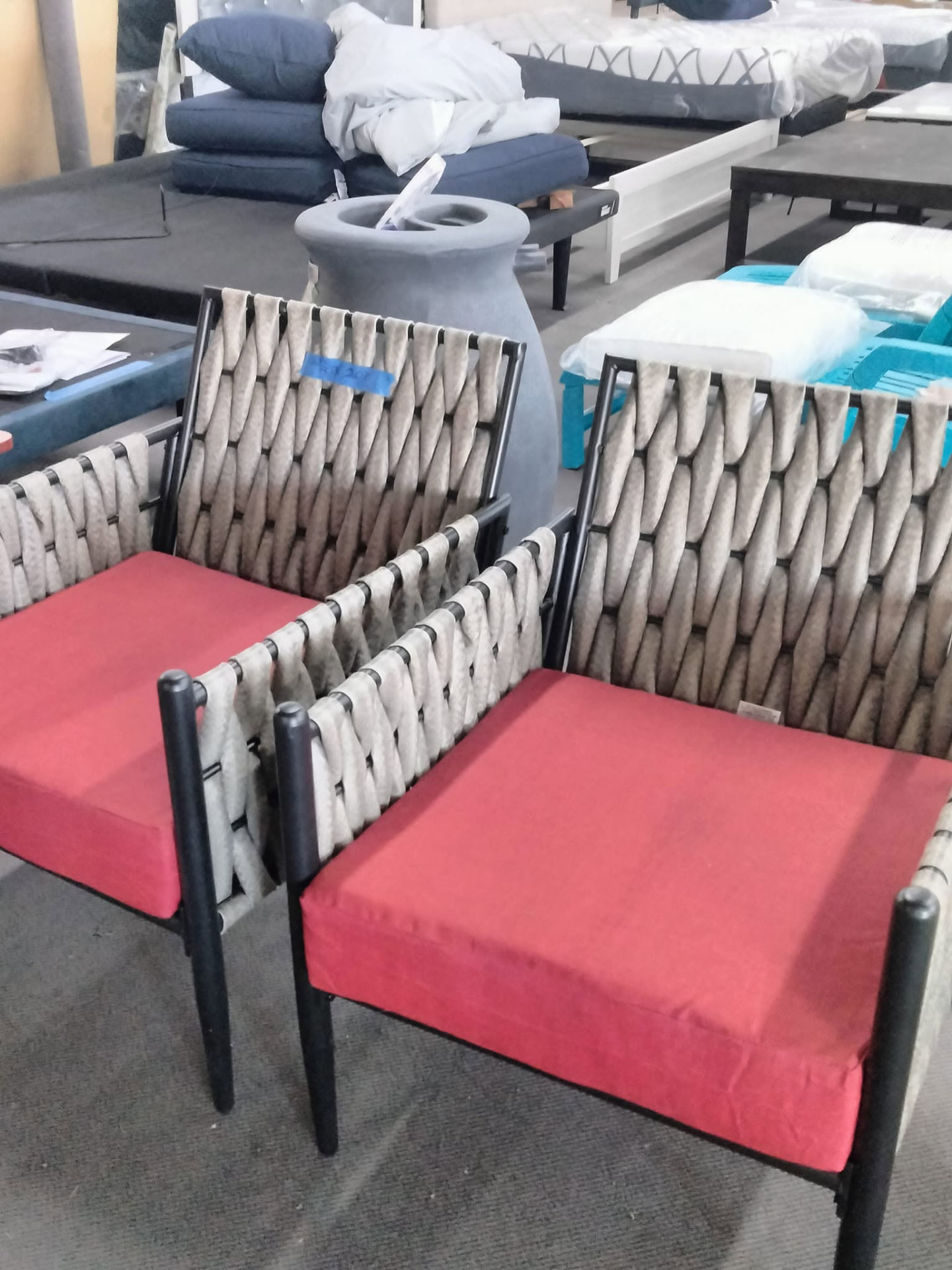 Red-cushioned outdoor accent chairs with metal frames