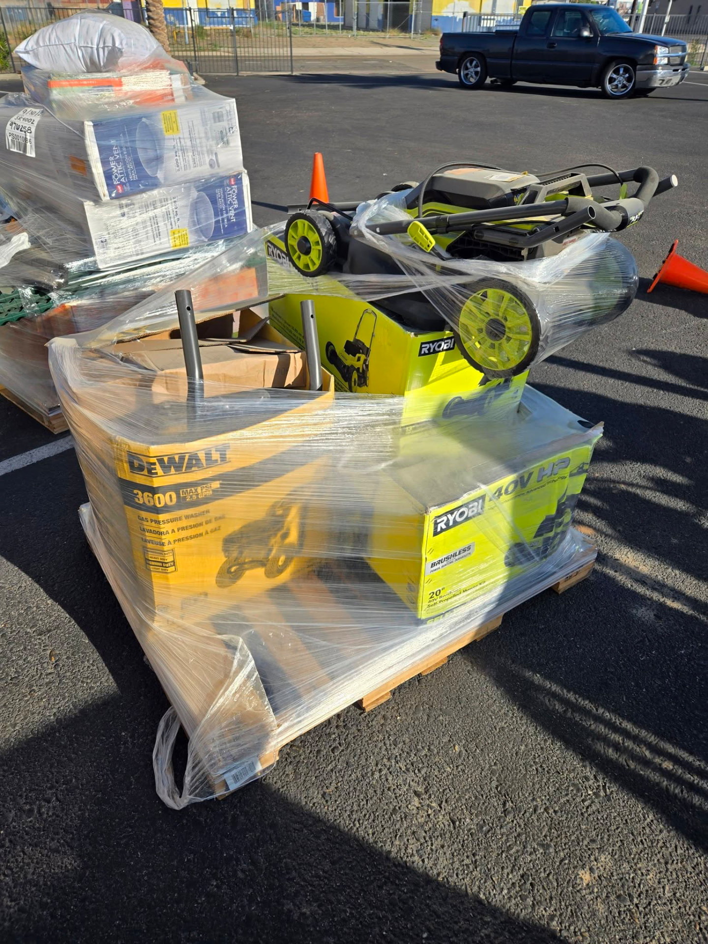 DeWalt pressure washer and Ryobi mower on a pallet