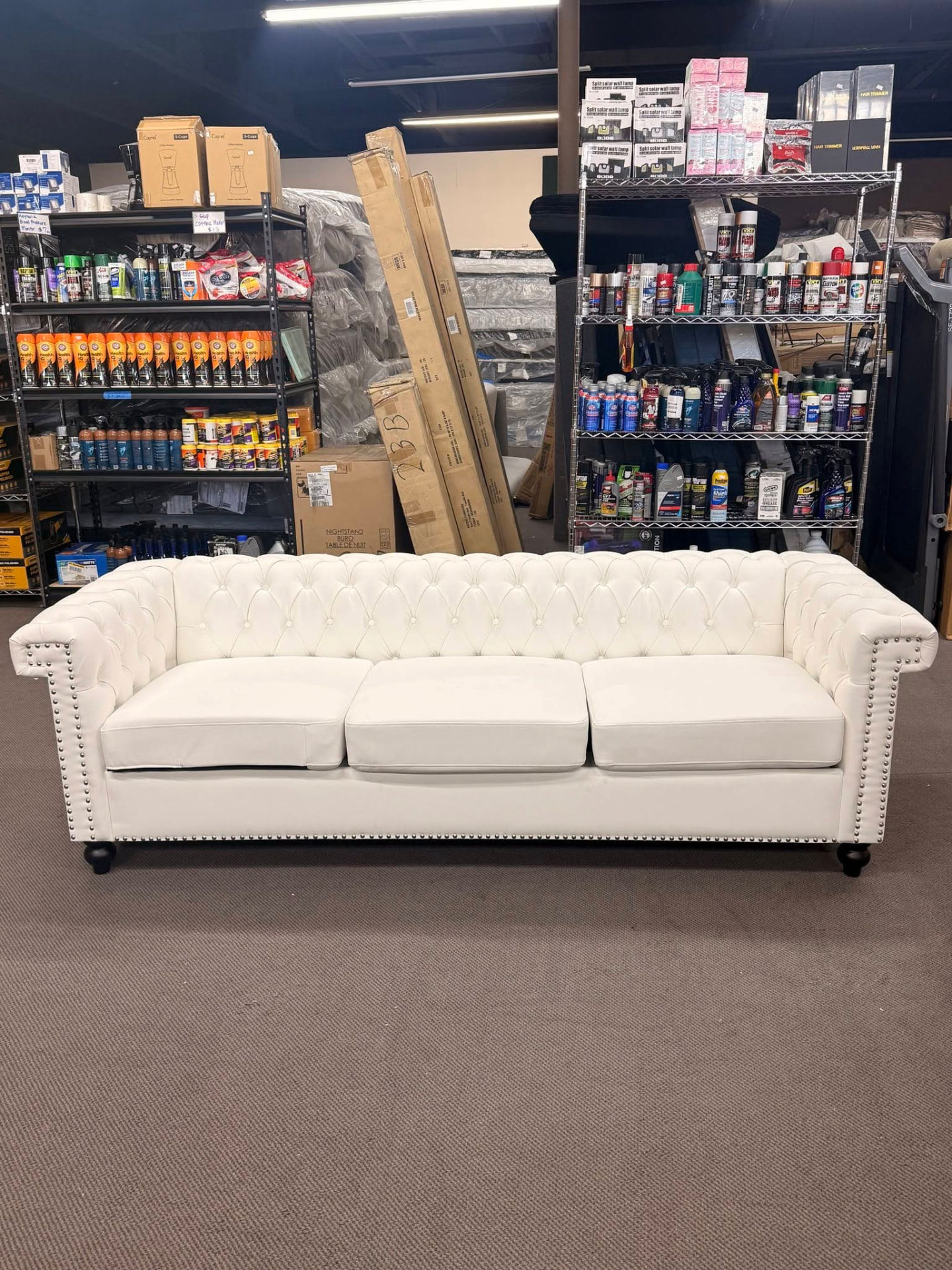 White tufted Chesterfield sofa in the showroom